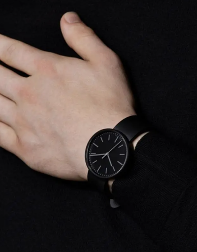 A man wearing a black Uniform Wares watch