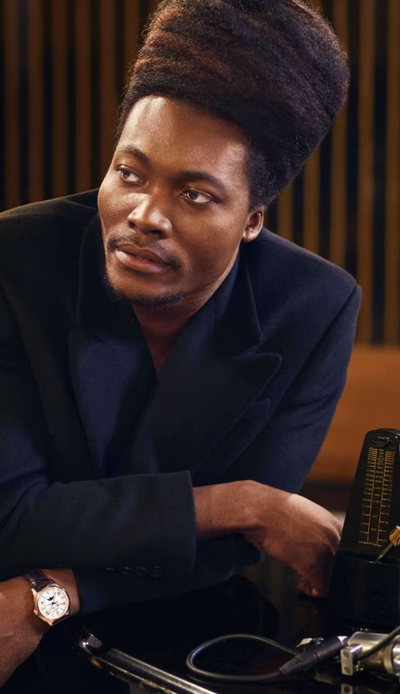 A man wearing a Vacheron Constantin watch and a black shirt