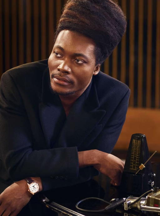 A man wearing a Vacheron Constantin watch and a black shirt