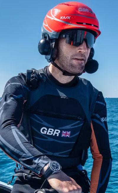 A man wearing a Rolex watch out on the water