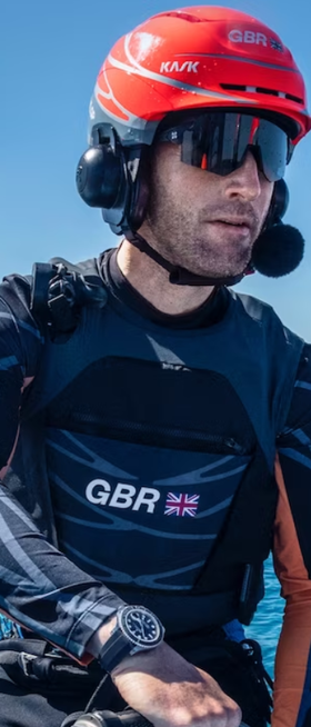 A man wearing a Rolex watch out on the water