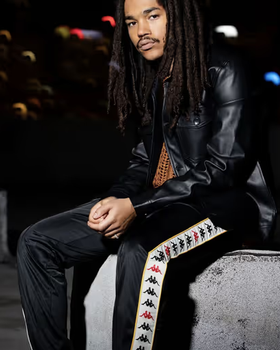 A man wearing a pair of black Kappa pants