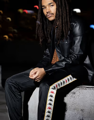 A man wearing a pair of black Kappa pants