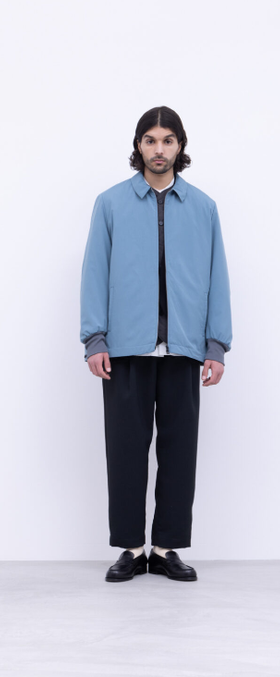 A man wearing a blue No Control Air and black pants