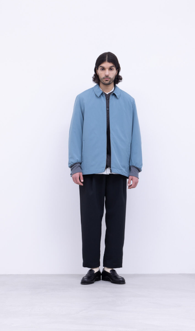 A man wearing a blue No Control Air and black pants