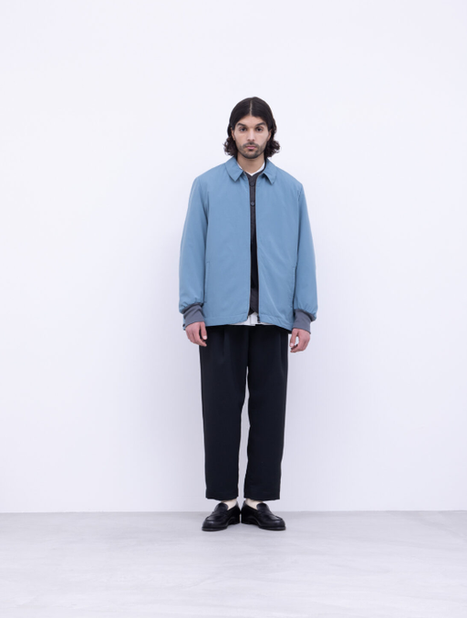 A man wearing a blue No Control Air and black pants