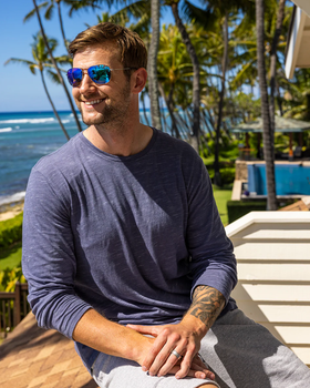 A man wearing a Maui Jim sunglasses and a blue long-sleeve