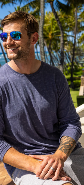 A man wearing a Maui Jim sunglasses and a blue long-sleeve