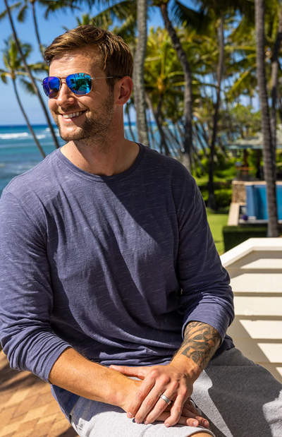 A man wearing a Maui Jim sunglasses and a blue long-sleeve