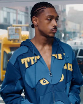 A man wearing a blue TELFAR outfit