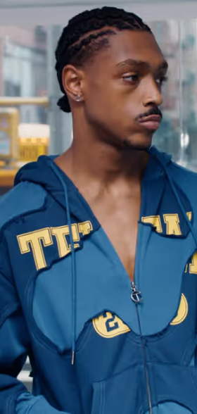 A man wearing a blue TELFAR outfit