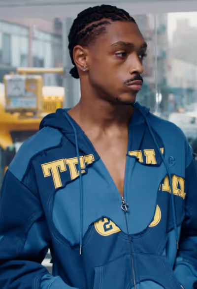 A man wearing a blue TELFAR outfit