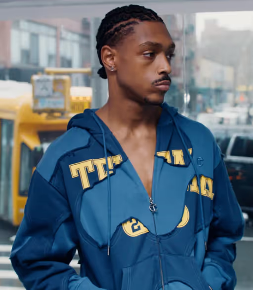A man wearing a blue TELFAR outfit