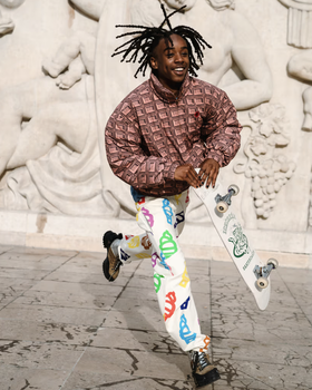 A man wearing an Ice Cream checkered shirt and a graphic pants