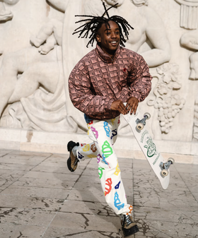 A man wearing an Ice Cream checkered shirt and a graphic pants