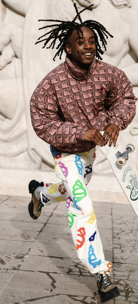 A man wearing an Ice Cream checkered shirt and a graphic pants