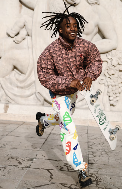 A man wearing an Ice Cream checkered shirt and a graphic pants