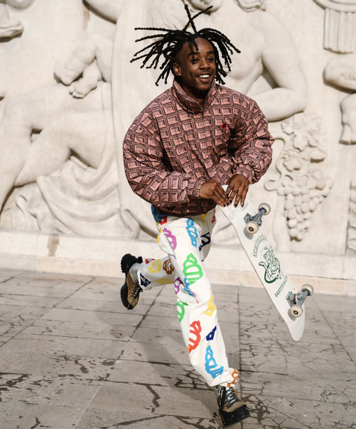 A man wearing an Ice Cream checkered shirt and a graphic pants