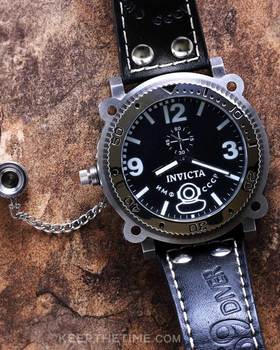A close-up of an Invicta black watch