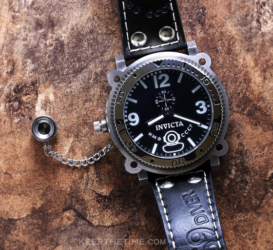 A close-up of an Invicta black watch