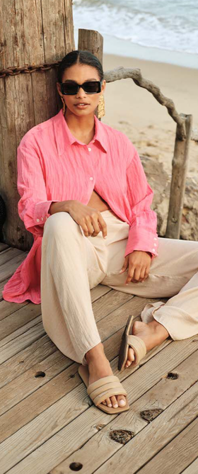 A man wearing a pair of HAVAIANAS and a pink shirt