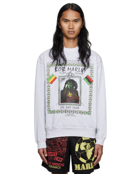 A man wearing a white Bob Marley Online Ceramics t-shirt and matching shorts
