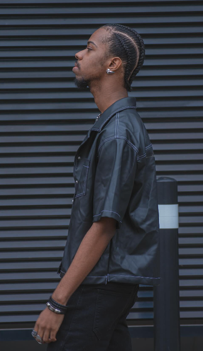 A man wearing a black VITALY button-up