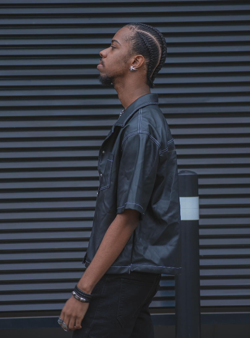 A man wearing a black VITALY button-up