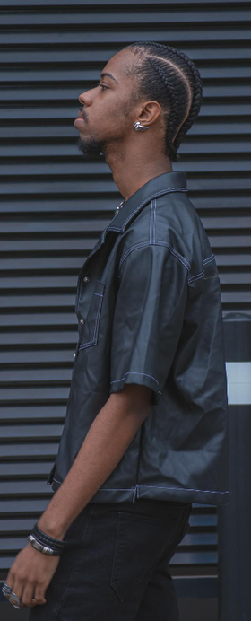 A man wearing a black VITALY button-up