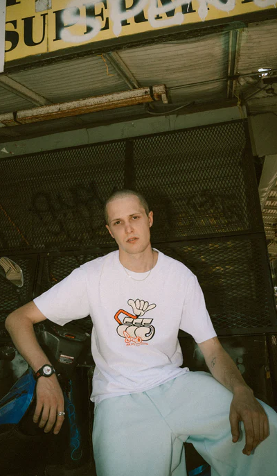 A man wearing a white Triple 5 Soul t-shirt