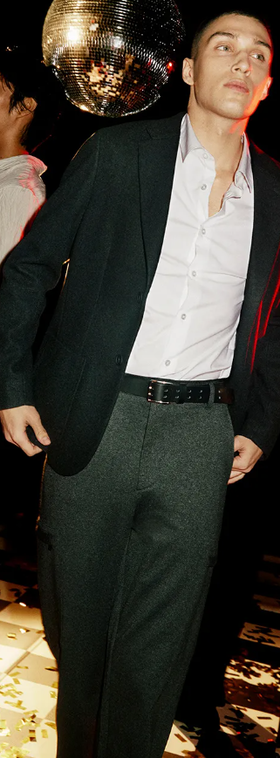 A man wearing a DKNY suit