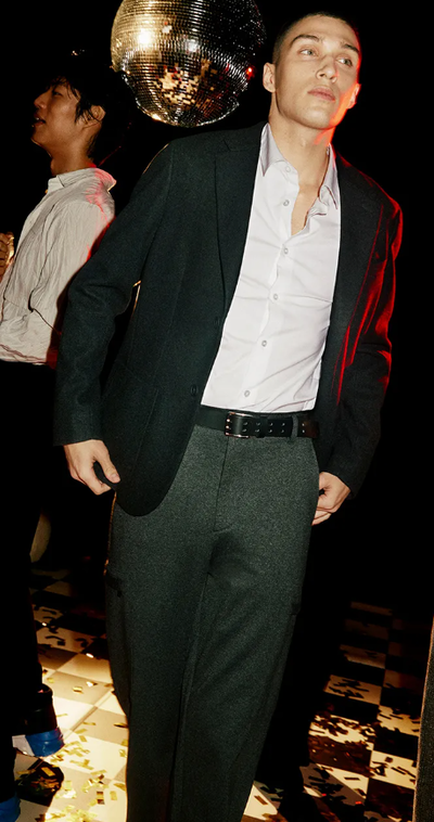 A man wearing a DKNY suit