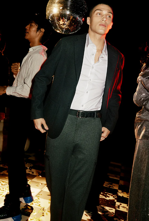 A man wearing a DKNY suit