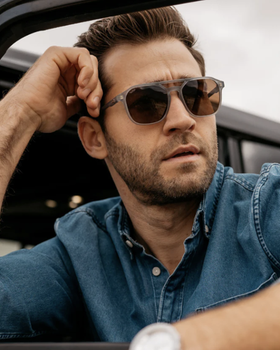 A man wearing a pair of Nick Square sunglasses and a denim jacket