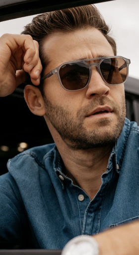 A man wearing a pair of Nick Square sunglasses and a denim jacket