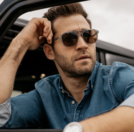 A man wearing a pair of Nick Square sunglasses and a denim jacket