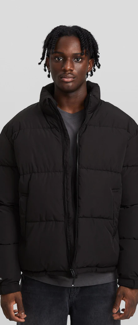 A man wearing a Bershka black jacket
