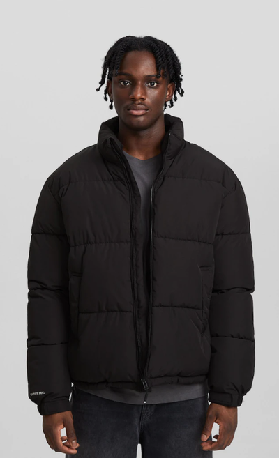 A man wearing a Bershka black jacket