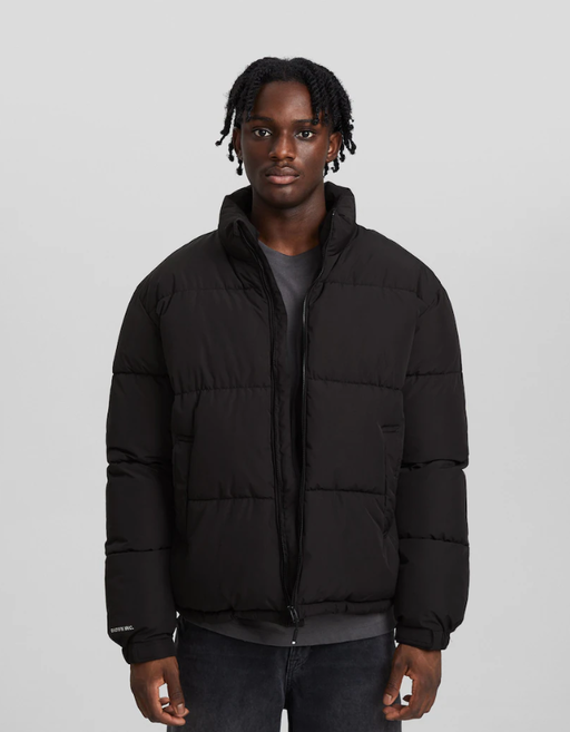A man wearing a Bershka black jacket