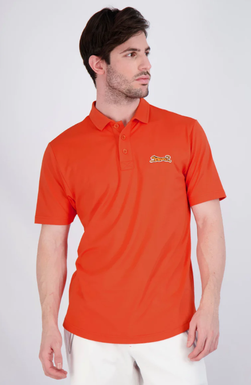 A man wearing a red Le Tigre polo shirt