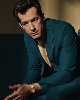A man wearing a Audemars Piguet watch and a blue suit