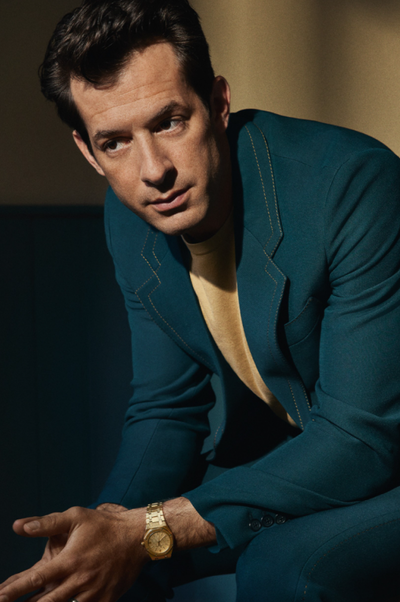 A man wearing a Audemars Piguet watch and a blue suit