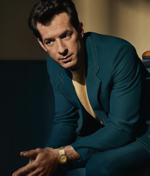 A man wearing a Audemars Piguet watch and a blue suit