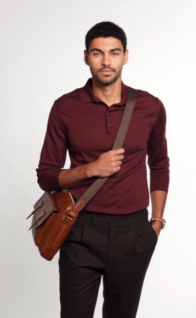 A man wearing a Fossil jacket and a rouge long-sleeve