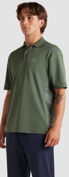A man wearing a Manors Golf green polo and black pants