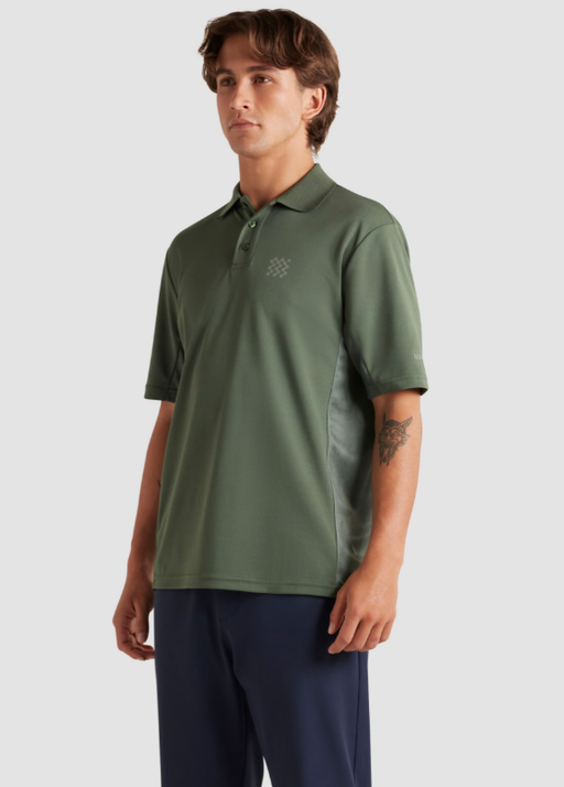 A man wearing a Manors Golf green polo and black pants