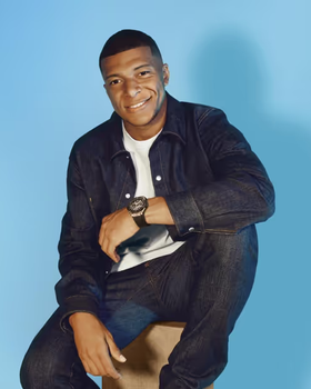 A man wearing a Hublot watch and a black shirt