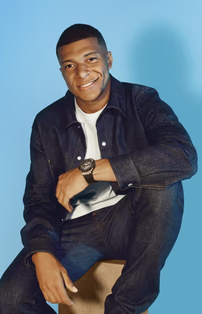 A man wearing a Hublot watch and a black shirt