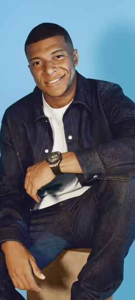 A man wearing a Hublot watch and a black shirt