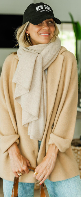 A woman wearing a Nordstrom beige shirt and scarf